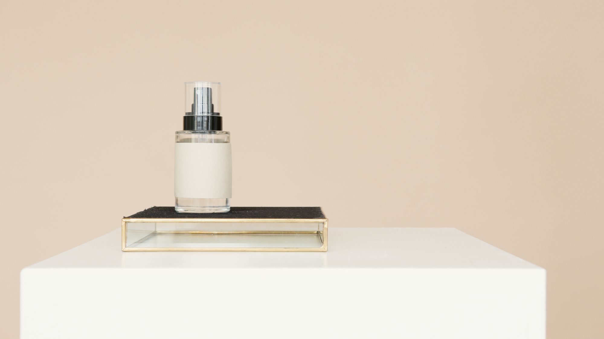 Orrin face oil in a glass dropper bottle on a white plinth